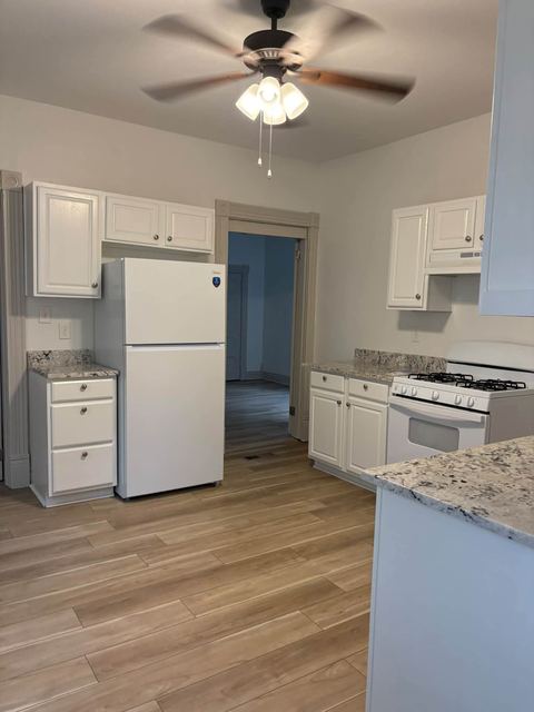 Kitchen with a white refrigerator and gas range